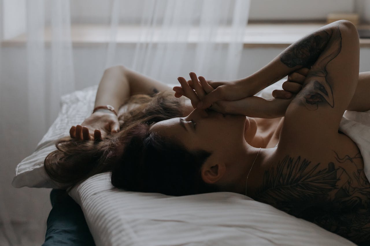 A serene moment between a couple lying in bed, showcasing affection and relaxation.